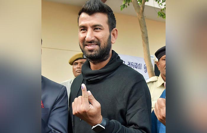 Cricketer Cheteshwar Pujara casts his vote in Rajkot's Ravi Vidyalaya booth.