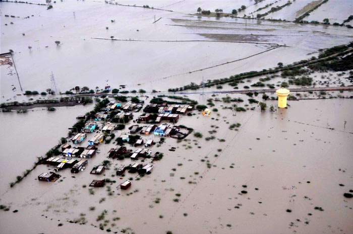 This photo shows submerged villages in Patan and Banaskantha districts as Air Force personnel approach with rescue teams. The water level in Sabarmati river has swollen due to heavy rain, leading to flooding in these areas.