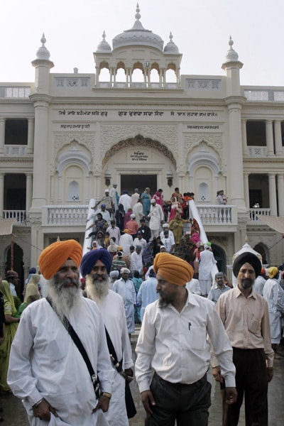 Sikh pilgrims visit the Gurdwara Sacha Sauda temple in Farooqabad, 85 kilometers (52 miles) west of Lahore, Pakistan on Sunday, Nov. 1, 2009. Thousands of Sikh pilgrims from all over the world arrived in Pakistan to participate in a three-day festival to celebrate the 541st birth anniversary of their spiritual leader Baba Guru Nanak, the founder of Sikh religion, at Nankana Sahib, which will begin on Nov. 2. (AP Photo)