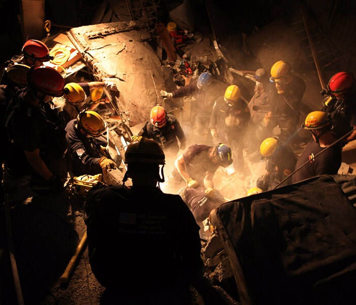 A Los Angeles County fire and rescue team works to extricate three women trapped in a collapsed building in downtown Port-au-Prince. (NYT photo)