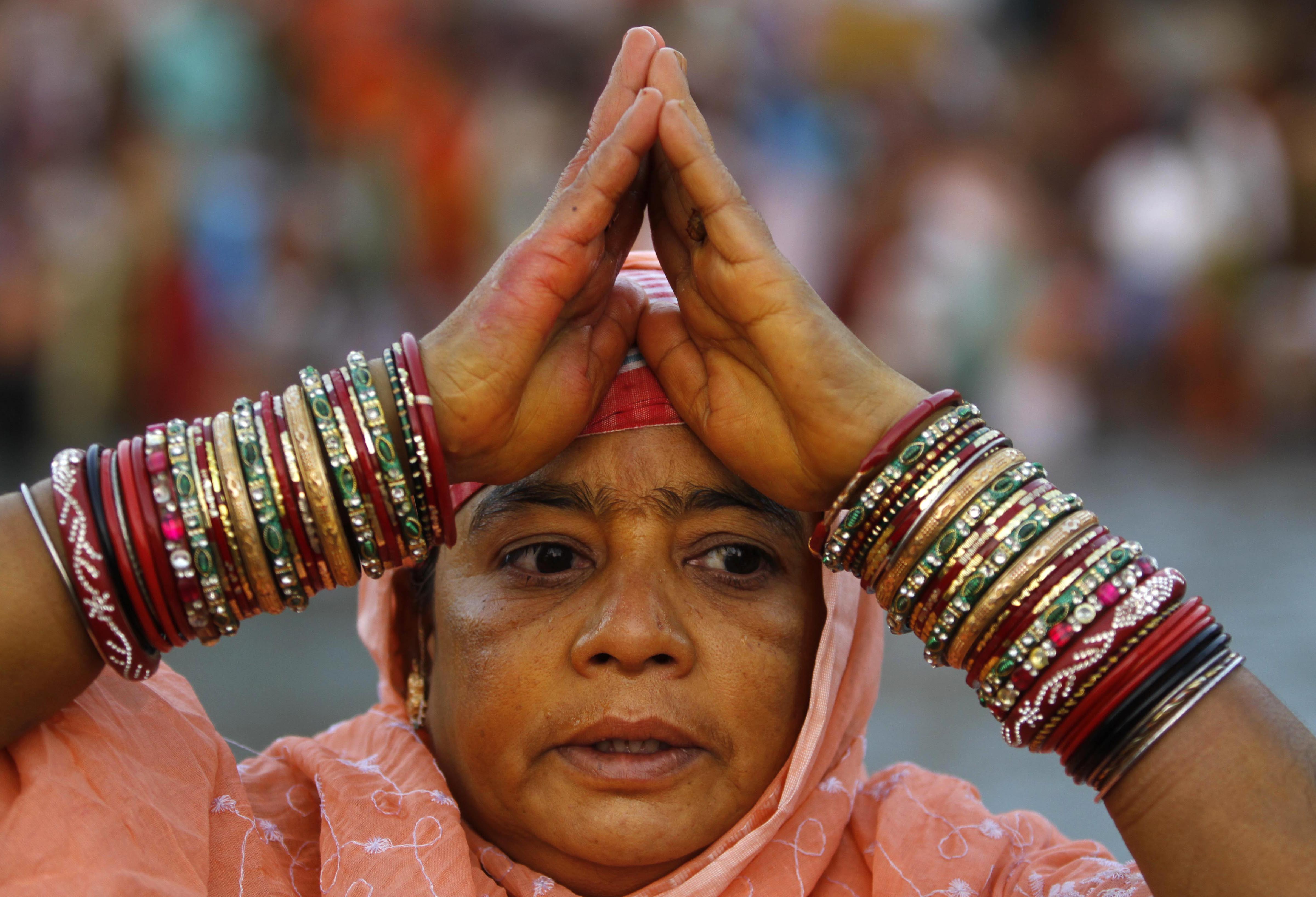 A devotee offers prayers on the banks of the River Ganga during the Kumbh Mela in Haridwar. (AP photo)