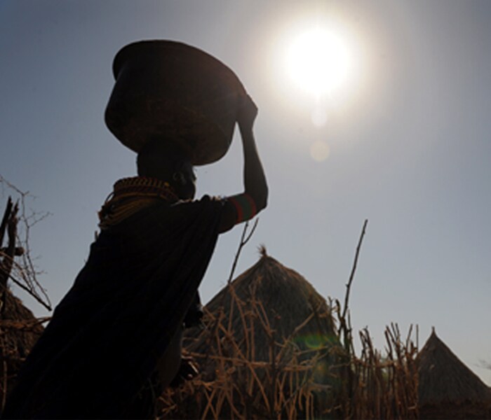 <b>Waiting for the special one:</b>A woman carrying water looks at the scorching sun with the expectation of an early onset of monsoon being more of a hope than anticipation.
Apart from being a relief from the ruthless summers, monsoon has always had an irreplaceable position in Indian hearts. (AFP image)