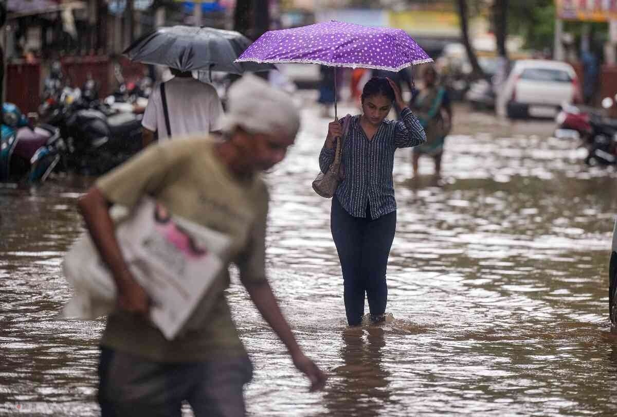 भारी बारिश के कारण शहर के कई निचले इलाकों में पानी भर गया, जिससे वाहनों की आवाजाही प्रभावित हुई और लोगों को जलमग्न सड़कों से गुजरते देखा गया. फोटो: पीटीआई