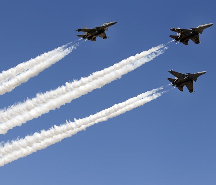 Indian air force Sukhoi Su-30 fighter aircraft fly in formation as they perform at the opening ceremony of Aero India 2011. (Photo courtesy: AP Photo)