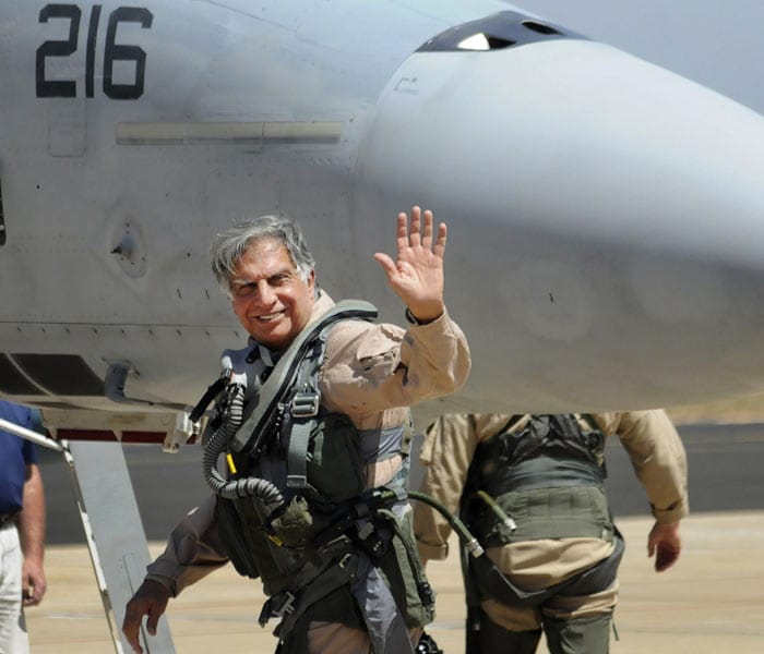 Tata Group chairperson Ratan Tata waves before boarding a Boeing fighter F/A-18 Super Hornet that he sits on back seat at the Aero India 2011 at the Yelahanka air base on the outskirts of Bangalore. (Photo courtesy: AP)