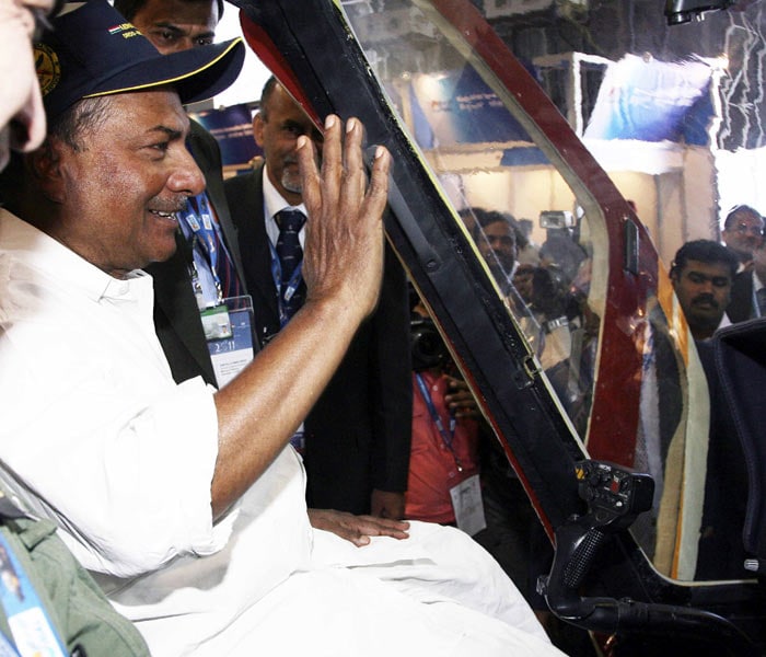 Defence Minister AK Antony waves from inside the cockpit of an aircraft after innaugurating the Aero India 2011 exposition in Bangalore. Aero India 2011 has drawn 675 firms and around 40 official delegations from 45 countries to Bangalore, India's aeronautical capital. The five-day airshow comes less than a month after Indian budget carrier Indigo agreed a $15.6-billion order for 180 A320 passenger aircraft with Europe's Airbus Industries. (Photo courtesy: AFP)