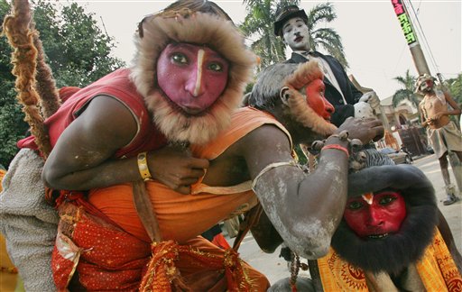 Participants are dressed as the army of the Hindu monkey god Hanuman as a Ramlila procession passes through a street of New Delhi, India, Monday, Oct. 2, 2006.  Ramlila is a theatrical representation of a myth on the life of Hindu God Ram, enacted in public places during the festival of Dussehra. On top right is a participant dressed as actor Charlie Chaplin.