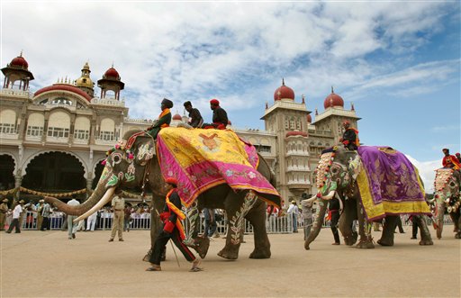 Mahouts lead decorated elephants as they walk past the Mysore Palace as part of the procession commemorating the last day of Dussera celebrations in Mysore, 145 kilometers (91 miles) south west of Bangalore, India, Monday, October 2, 2006. According to Hindu mythology the festival celebrates the slaying of the demon Mahishasura by the Goddess Chamundeeswari or Durga and the triumph of good over evil.