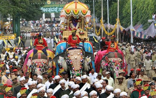 An idol of Hindu goddess Chamundeeswari, placed in a gold howdah is carried on an elephant through the streets on the last day of Dussera celebrations in Mysore, 145 kilometers (91 miles) south west of Bangalore, India, Monday, October 2, 2006. According to Hindu mythology the festival celebrates the slaying of the demon Mahishasura by the Goddess Chamundeeswari or Durga and the triumph of good over evil.