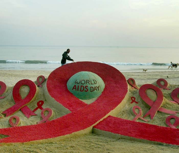 The red ribbon was introduced as a symbol of AIDS unity in early 90s. Today it stands for more than just that, essaying dedicated support for the cause.<br><br>Seen here is an AIDS-awareness sand sculpture created by artist Sudarshan Pattnaik ahead of World Aids day at Golden Sea beach in Puri. (AFP Photo)