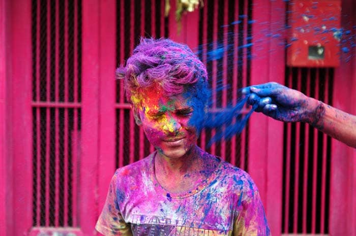 A child get his face smeared with colours as he takes part in Holi celebrations in Chennai. (AFP Photo)