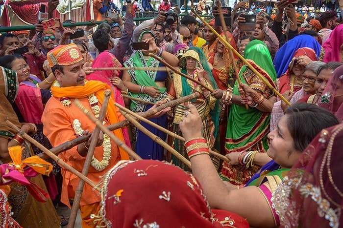 Holi 2022: People celebrate Lathamaar Holi in Vrindavan, Uttar Pradesh. (PTI)