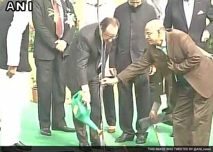 French President Francois Hollande plants a tree in Rajghat.