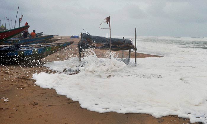 High tide touches the boats parked far from the sea in Gopalpur due to cyclone 'Hudhud' in Ganjam district of Odisha on Sunday