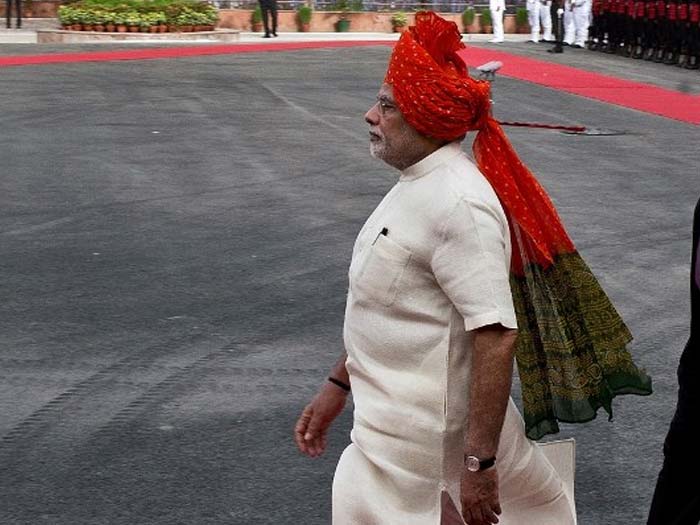 India's Prime Minister Narendra Modi walks to the guard of honour for the country's 68th Independence Day at the Red Fort in New Delhi on August 15, 2014.