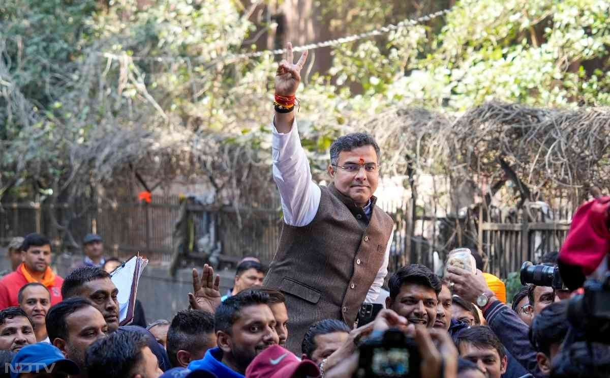 BJP candidate from New Delhi assembly constituency Parvesh Verma celebrates outside a counting center in New Delhi.