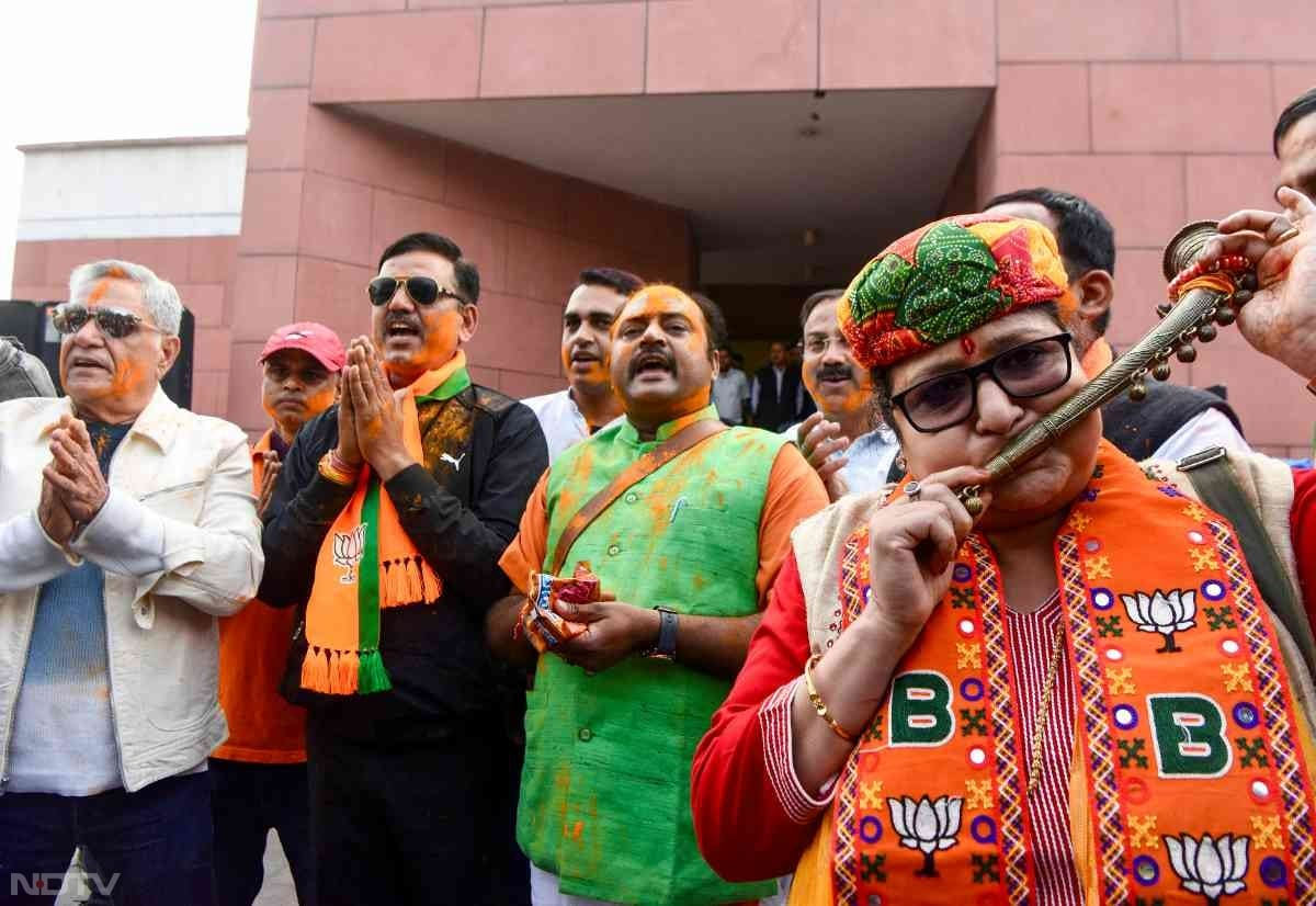 Bharatiya Janata Party workers celebrate the party's win in the Maharashtra Assembly Elections at party HQ in New Delhi