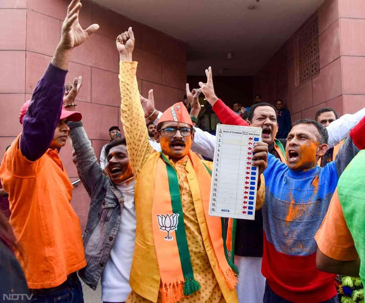 BJP workers celebrate the party's win in the Maharashtra Assembly Elections in New Delhi