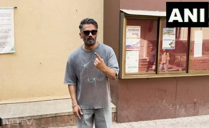 Actor Sunil Shetty shows his inked finger after casting vote at a polling booth in Mumbai