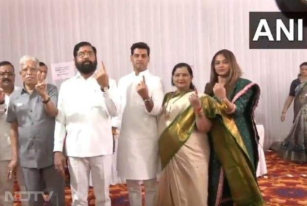 Maharashtra chief minister Eknath Shinde along with his family show their inked fingers after casting vote in Thane