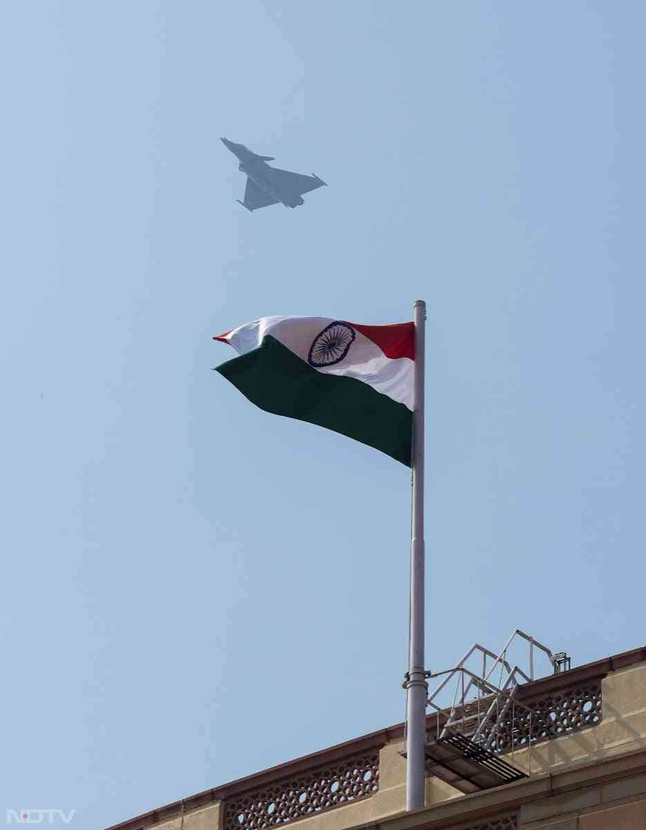 Indian Air Force's Rafale aircraft flies past the Samvidhan Sadan during the full dress rehearsal