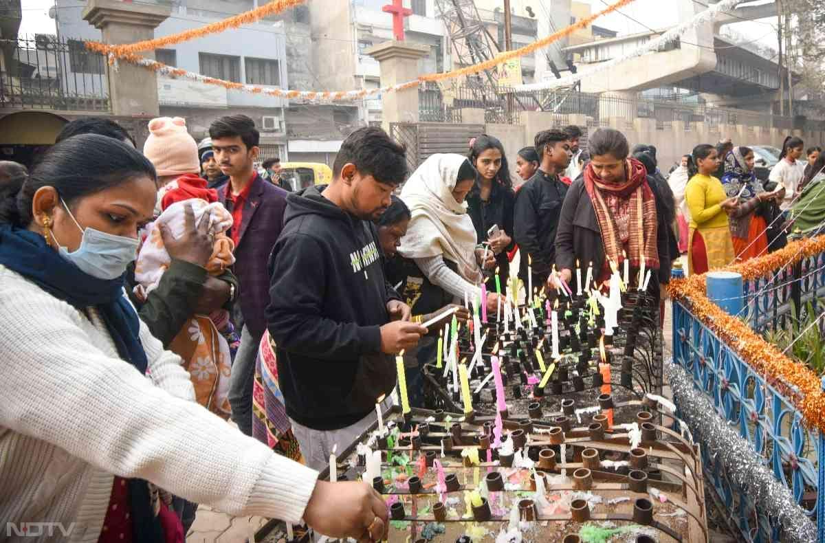 Christians light candles at a church on the occasion of Christmas in Patna