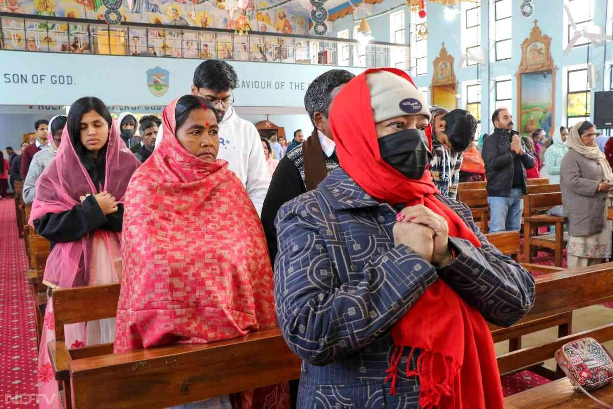 Devotees pray during Christmas celebrations at St. Mary's Cathedral in Jammu