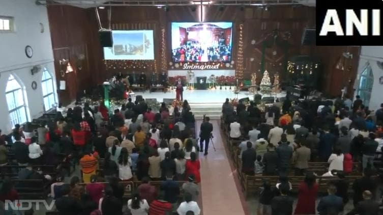 People gather to offer prayers on Christmas Eve at MBC Centre Church in Imphal