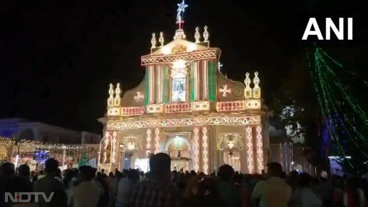 People gather for the midnight mass prayers at Sacred Heart Basilica Church on Christmas Eve in Puducherry