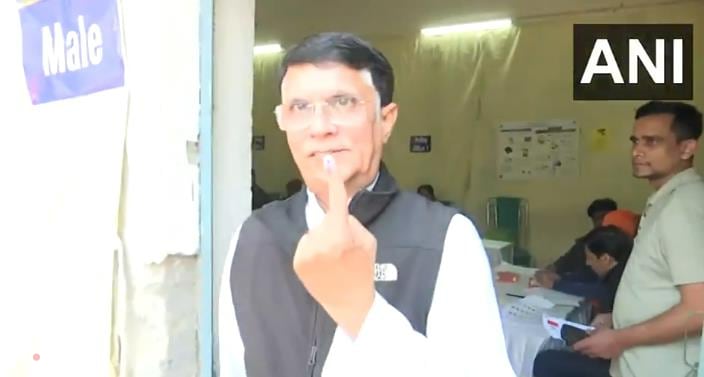 Congress leader Pawan Khera shows his inked finger after casting his vote at a polling booth in Nizamuddin East