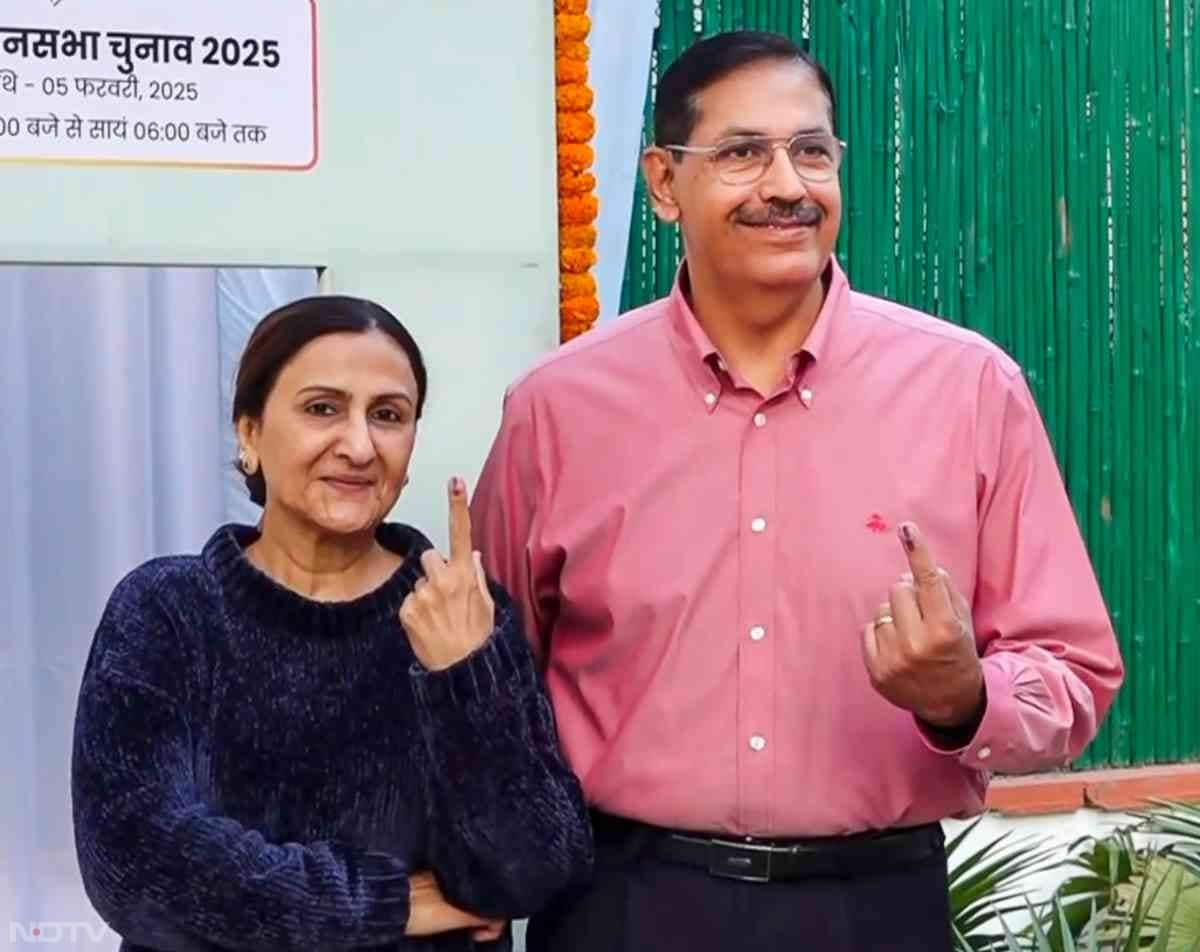 Delhi Police Commissioner Sanjay Arora shows his inked finger after casting his vote at a polling booth in New Delhi