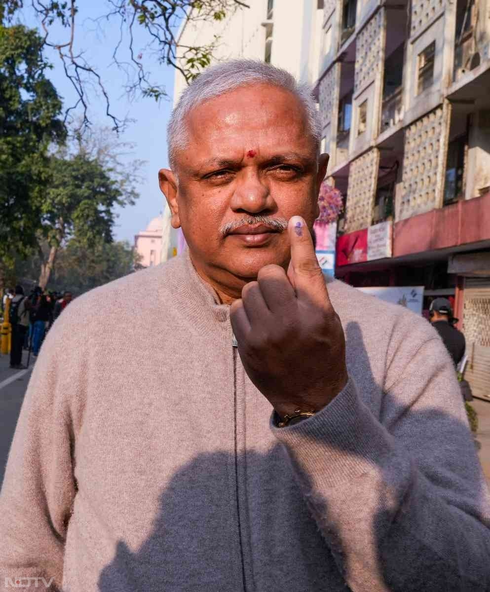 BJP National General Secretary B.L. Santhosh shows his inked finger after casting his vote at a polling booth in New Delhi