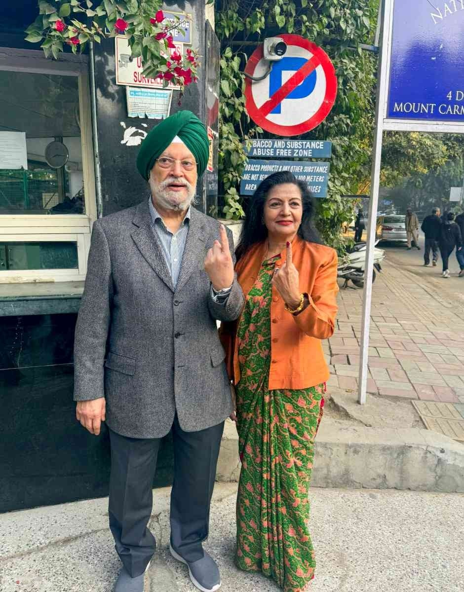 Union Minister Hardeep Singh Puri and his wife Lakshmi Puri show inked fingers after casting votes at a polling booth in Green Park