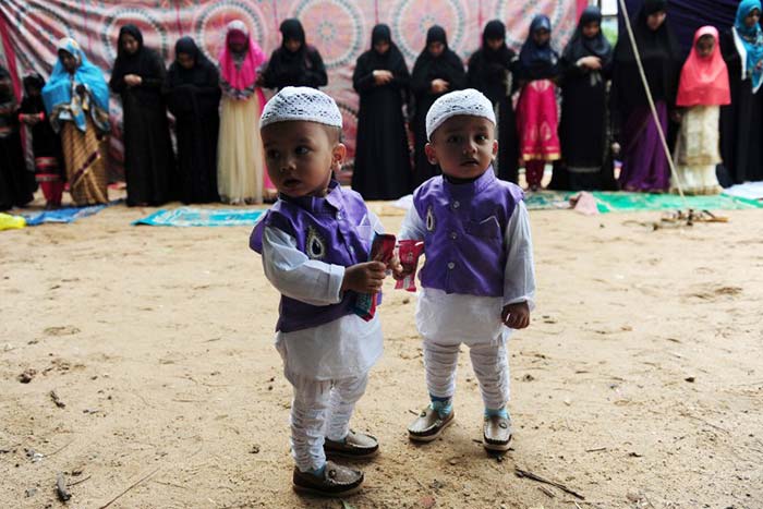 Children look on as people offer Eid al-Fitr prayers in Chennai. (AFP Photo)