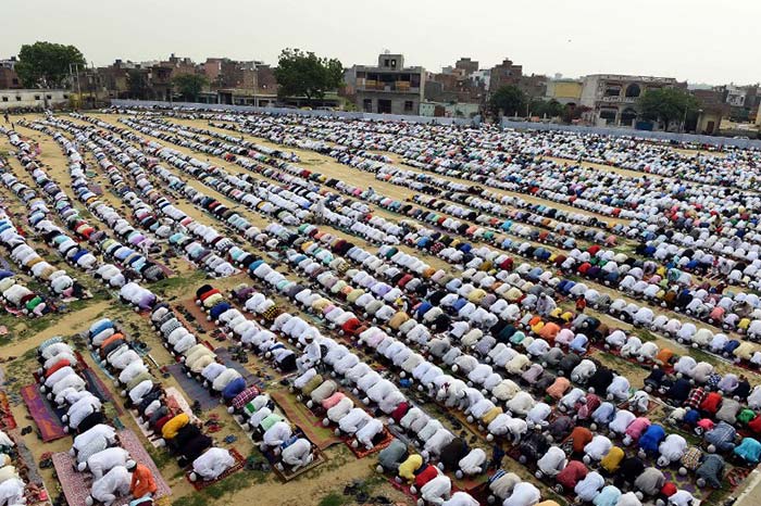 People offer Eid prayers at Eid Gah Ground in Pasonda, Ghaziabad some 30 kms east of New Delhi. (AFP Photo)