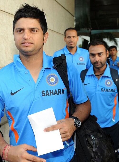 Suresh Raina, Yusuf Pathan and Amit Mishra walk to the team bus in Mumbai on September 18. India left for South Africa keen to maintain their consistency to fulfill their fans' expectations at the Champions Trophy from September 22 - October 5. (AFP Photo)