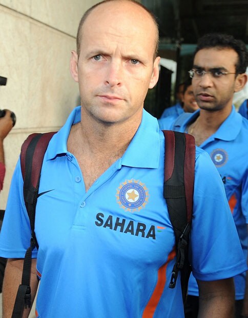 Coach Gary Kirsten walks to the team bus in Mumbai on September 18. India left for South Africa keen to maintain their consistency to fulfill their fans' expectations at the Champions Trophy from September 22 - October 5. (AFP Photo)