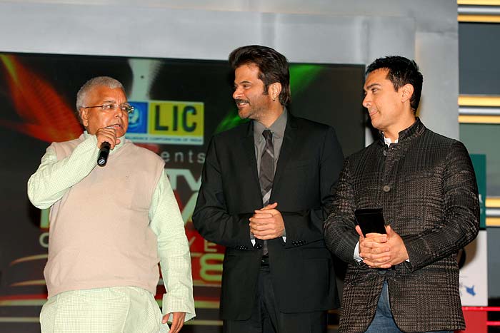 Railway Minister Laloo Prasad Yadav about to announce an Indian of the Year awardee - Anil Kapoor looks on.
