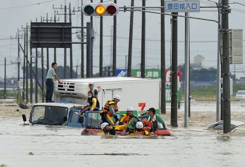 People are rescued from vehicles by firefighters at an area flooded by the Kinugawa river, caused by typhoon Etau, in Joso, Ibaraki prefecture, Japan on September 10, 2015. (Reuters/Kyodo)