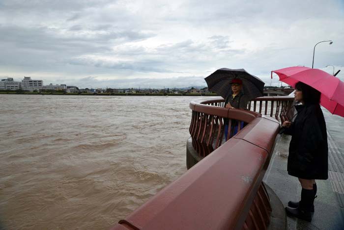 Residents are seen as they wait for rescue helicopters at a residential area flooded by the Kinugawa river in Japan on September 10, 2015. (Reuters/Kyodo)