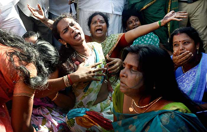 Supporters of Ms Jayalalithaa seen crying after she was sentenced to four years in jail. (Press Trust of India photo)