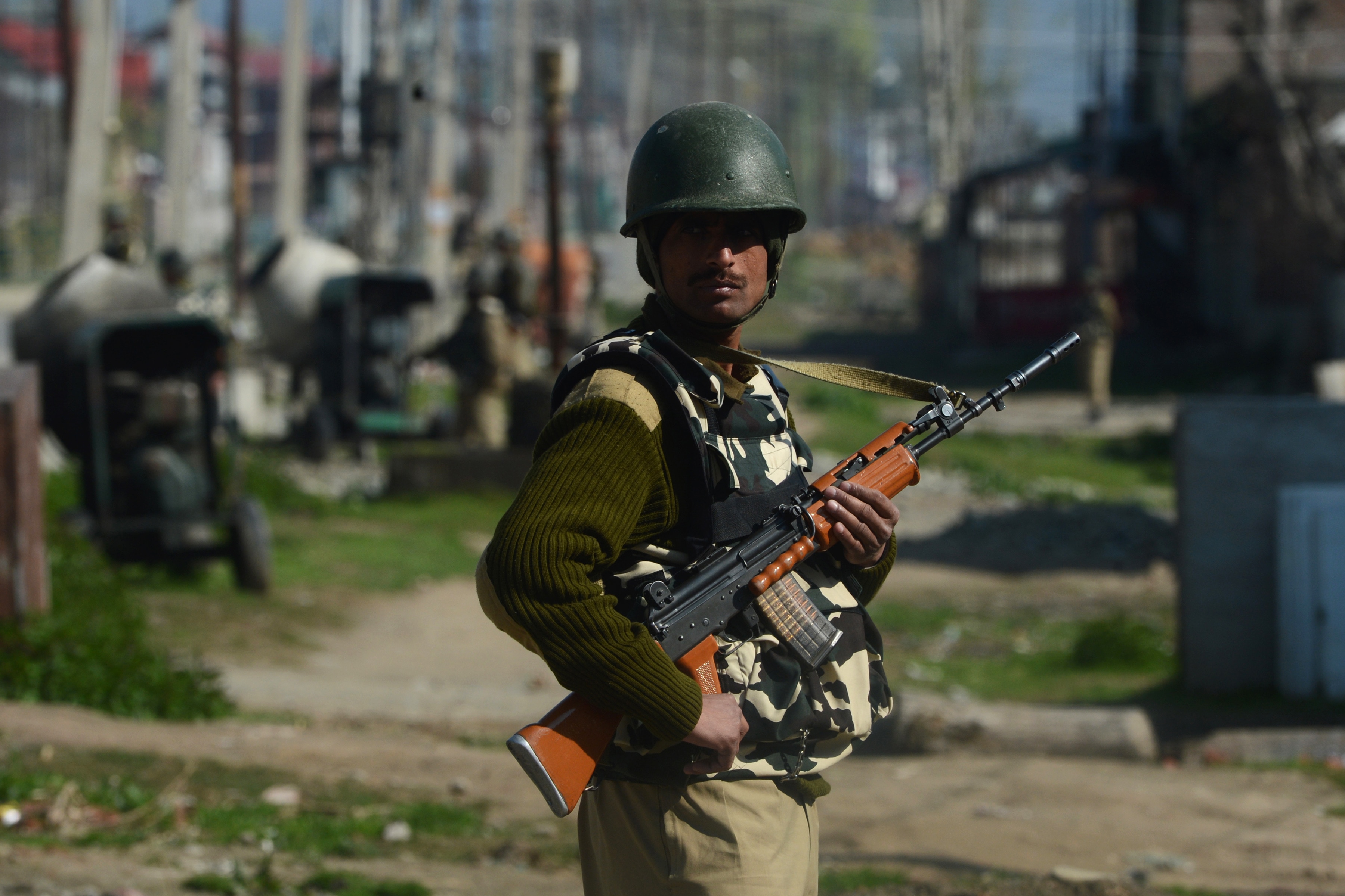 A Paramilitary trooper stands guard near the vicinity of a gunfight between suspected militants and Indian troops in the outskirts of Srinagar on April 14, 2014. Militants have tried repeatedly to derail the ongoing elections by carrying out deadly attacks on village elders