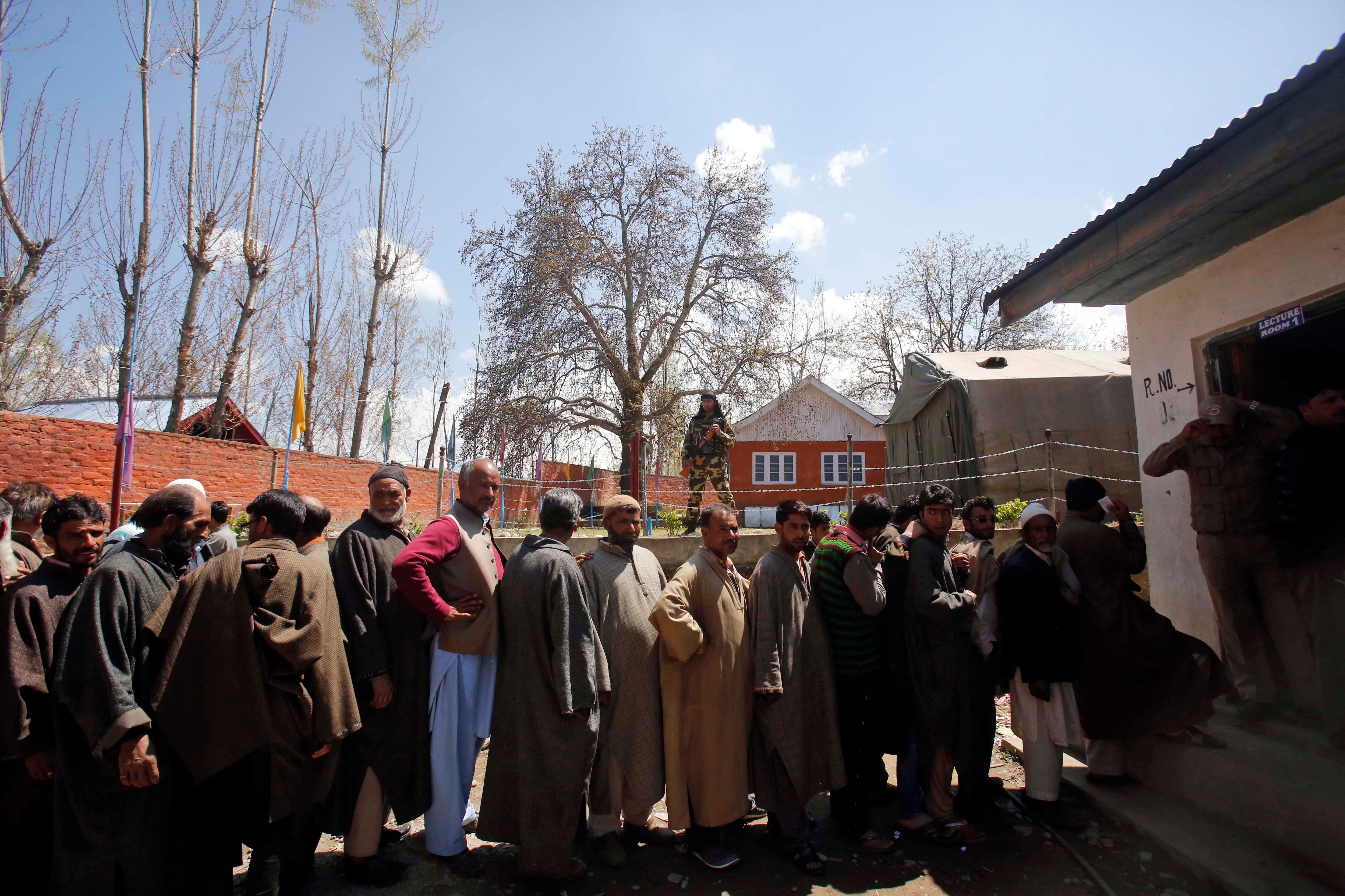 Kashmiris stand in a queue to cast their votes at a polling station at Damhal Hanji Pora, some 85 kilometers south of Srinagar