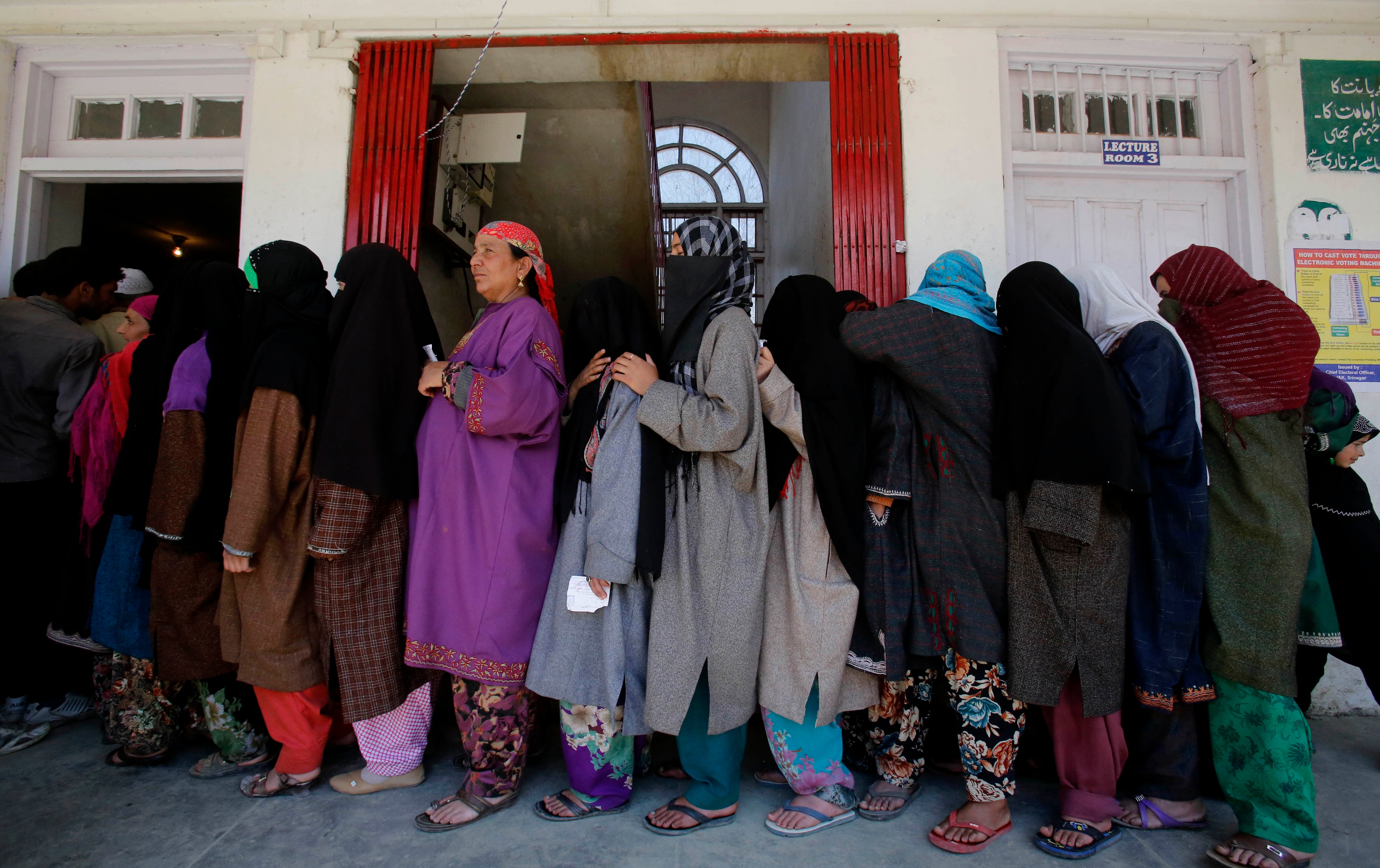 Kashmiri women stand in a queue to cast their votes at a polling station at Damhal Hanji Pora, some 85 kilometers south of Srinagar