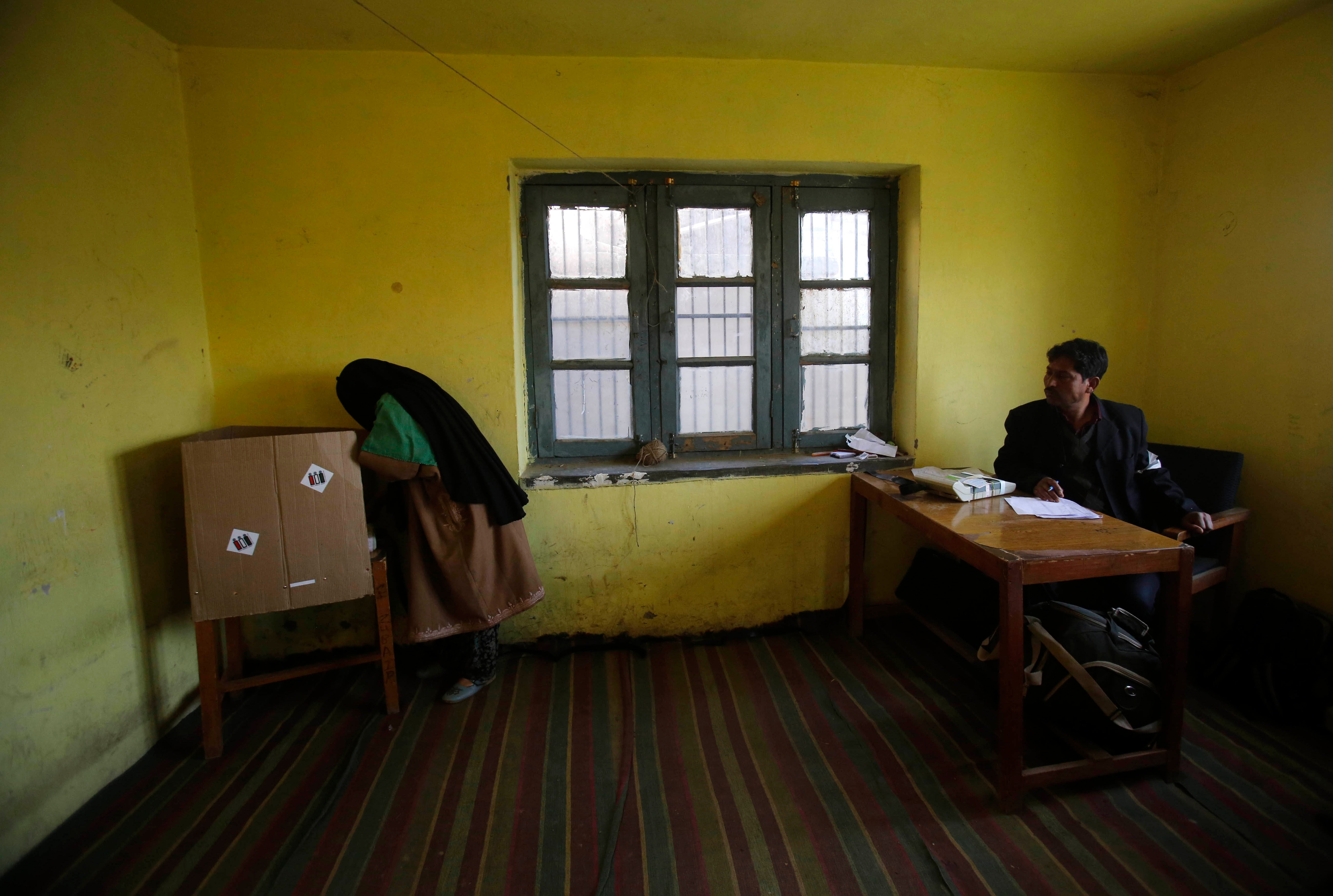 A Kashmiri woman casts her vote at a polling station in Bragpora, some 65 kilometers south of Srinagar. Militants determined to derail elections have carried out three deadly attacks on village elders in the last week to spread fear among the people