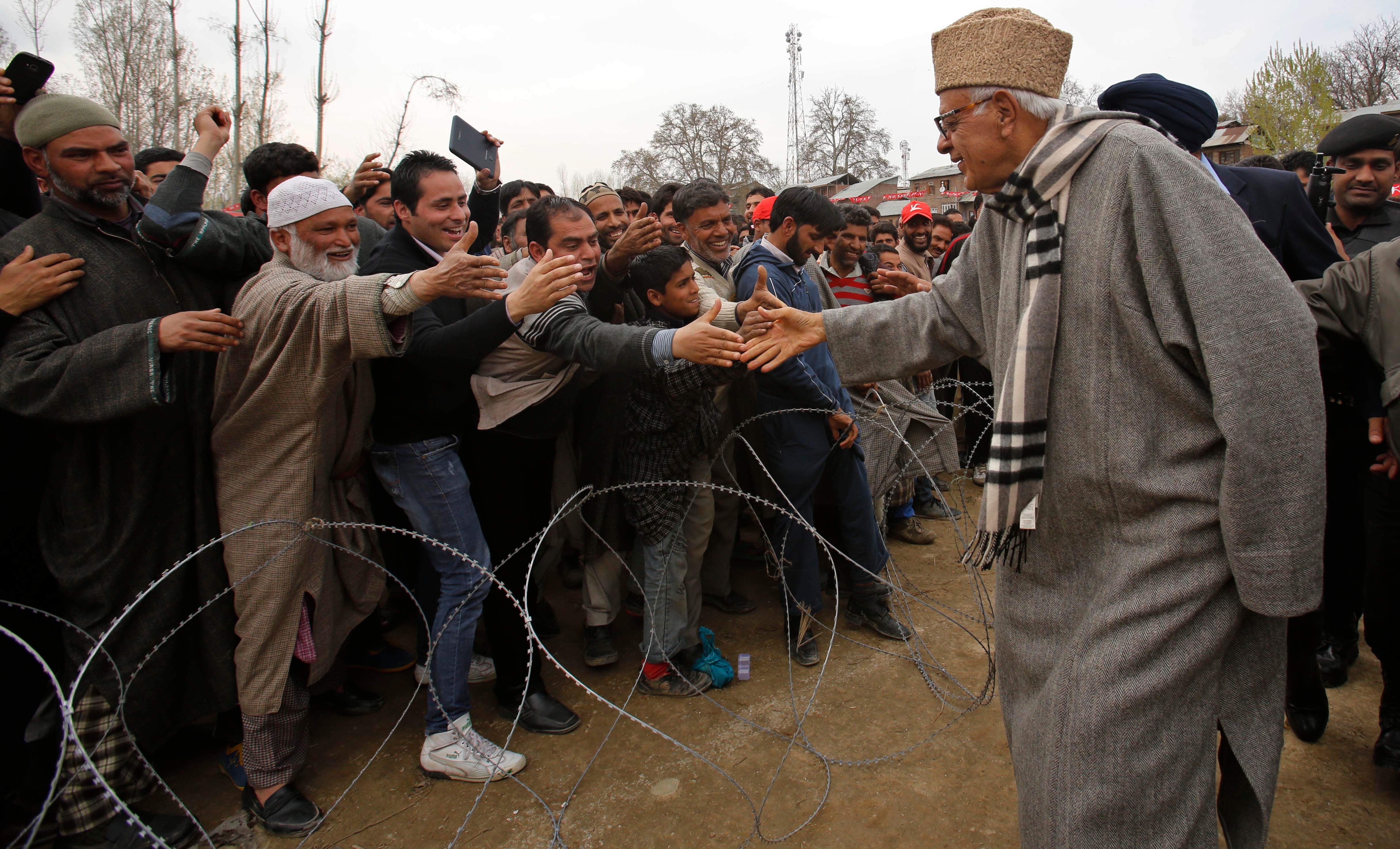 Kashmir's National Conference party leader Farooq Abdullah, shakes hand with his supporters at an election campaign rally in Chadoora, outskirts of Srinagar. India's multiphase voting runs until May 12, with results for the 543-seat lower house of Parliament expected on May 16, 2014