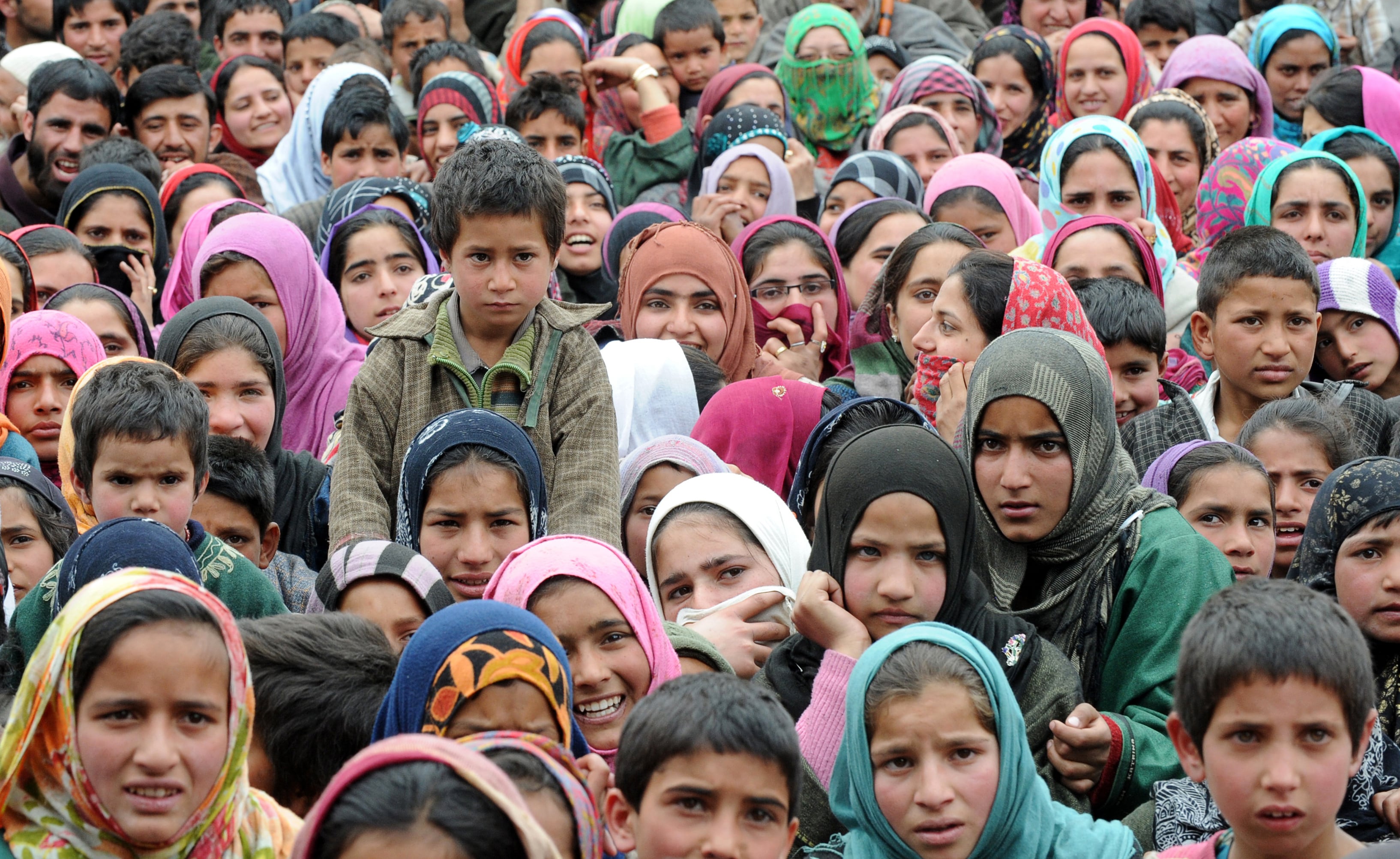 Supporters listen to National Conference Party Leader Farooq Abdullah as he addresses an election rally in the village of Rawalpora in Budgam District some 55kms from Srinagar on April 15, 2014