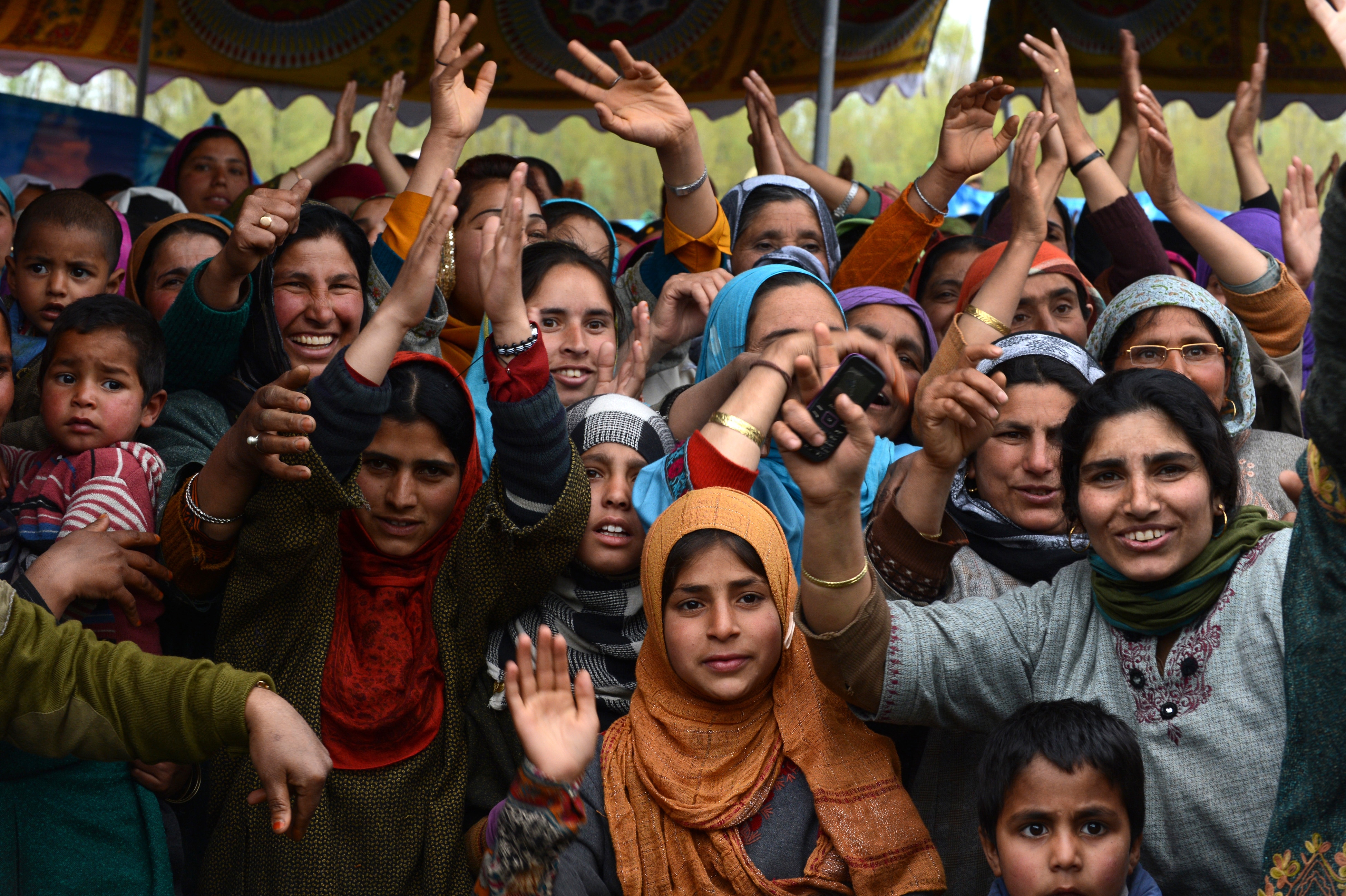 Supporters of Kashmir's main opposition party, Peoples Democratic Party (PDP) shout slogans at a campaign rally addressed by party patron Mufty Mohammed Syeed (unseen) amid tight security