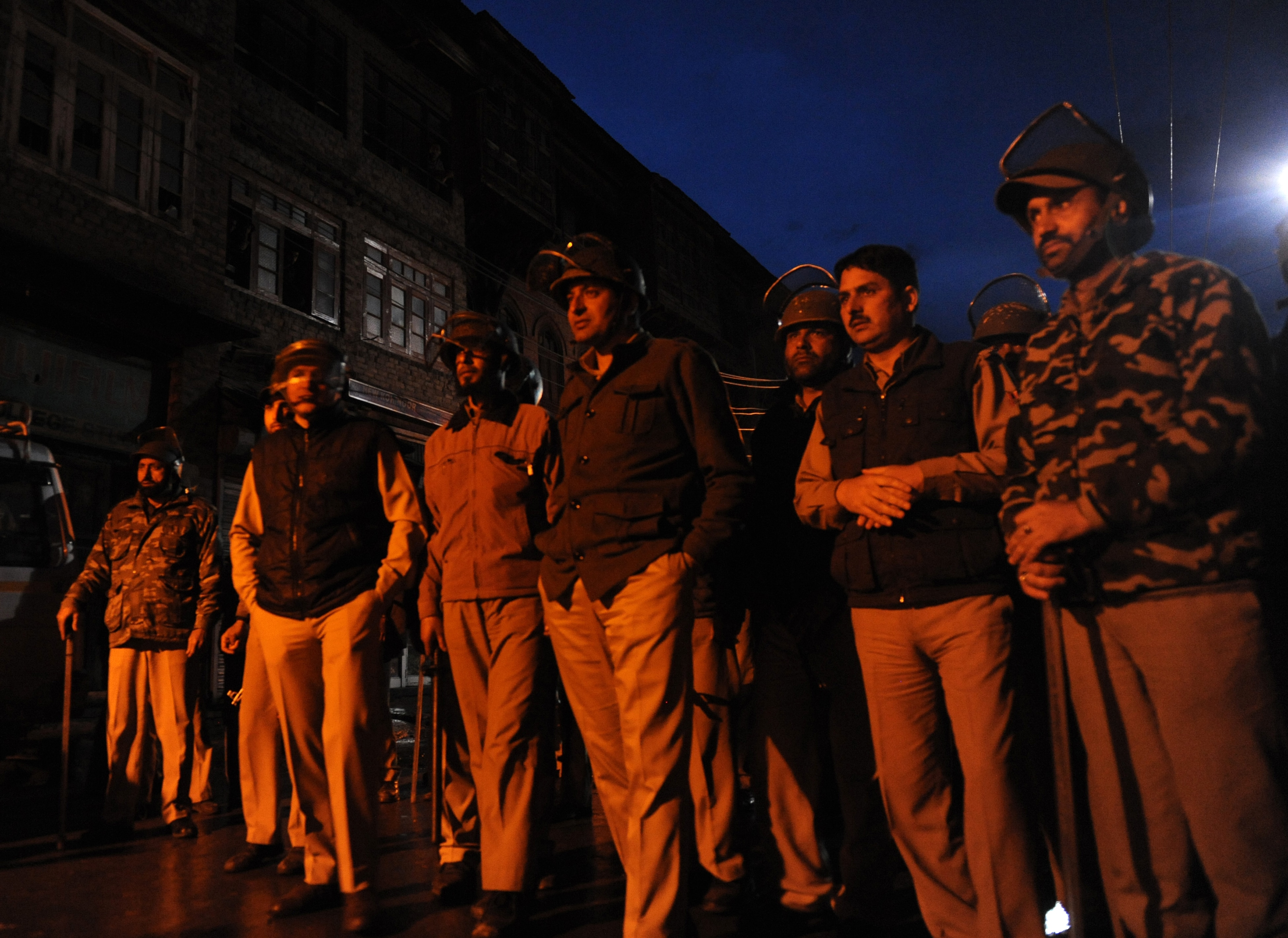 Policemen stand guard as Jammu Kashmir Liberation Front (JKLF) activists hold a rally against the ongoing general elections in Srinagar