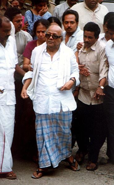 Karunanidhi followed by his supporters as he proceeds to a Madras jail after being arrested early 30 June 2001. Karunanidhi, along with scores of Dravidia Munnetra Kazagam (DMK) party officials were arrested for alleged corruption. AFP PHOTO